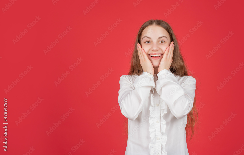 amazed child hold face express positive emotions on red background copy space, flash sales. amazed child hold face express positive emotions on red background copy space, flash sales.