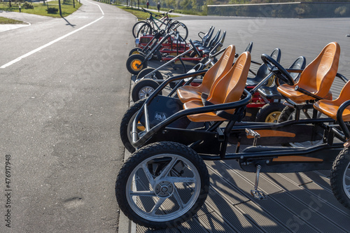 Bicycle rental in the city park. Velomobiles are parked in the park. photo