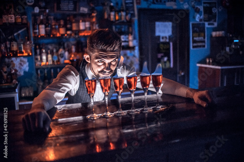 Bartender makes a cocktail in the public house photo