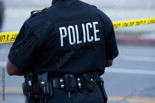 Carta da parati Detailed view of police uniform and cordon tape sealing off an active crime scene