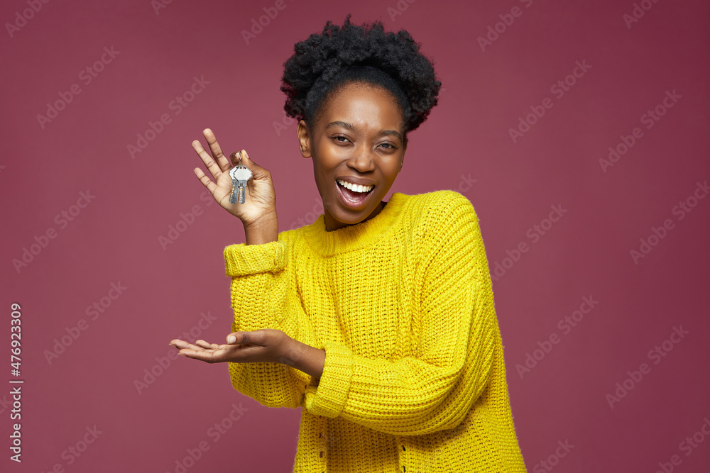 Joyful excited african american woman hold home key in hand buying modern apartment. Black woman win new flat in lottery Joyful excited african american woman hold home key in hand buying modern apartment. Black woman win new flat in lottery