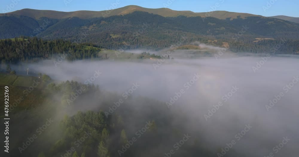 The mountains of the Carpathians at dawn are covered with thick fog The mountains of the Carpathians at dawn are covered with thick fog