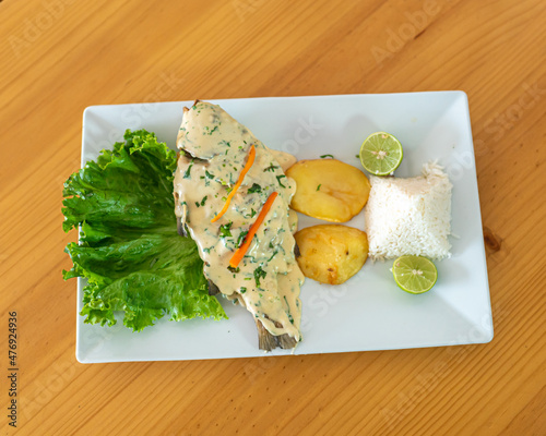 Menier fish with golden potatoes, lettuce and rice. Peruvian food. photo