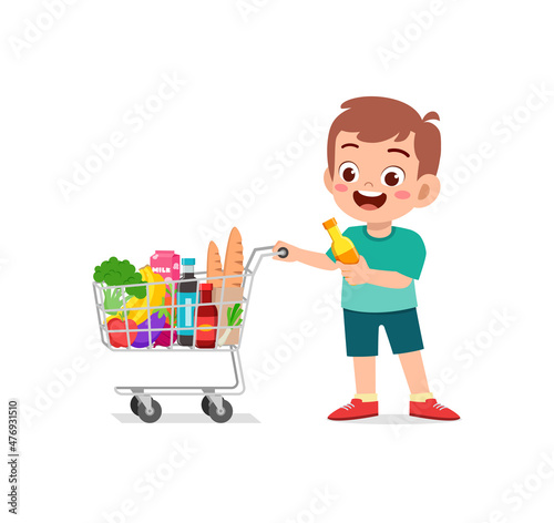 cute little boy push shopping cart full of groceries