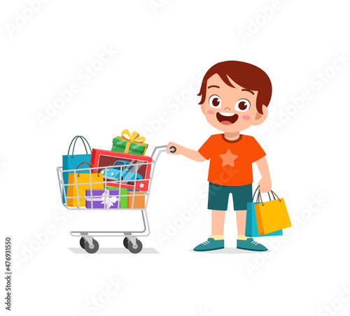 cute little boy push shopping cart full of groceries