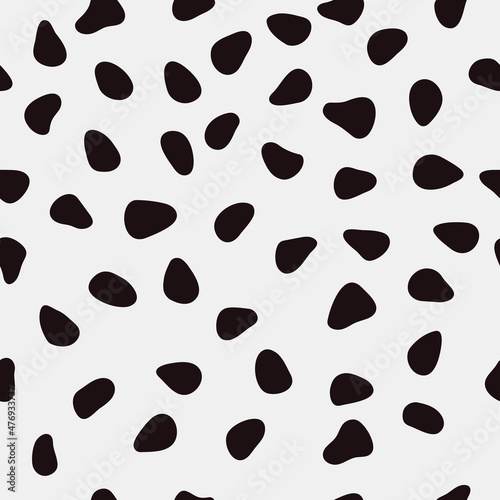 Black shapeless spots on a white background. Vector with seamless spots.