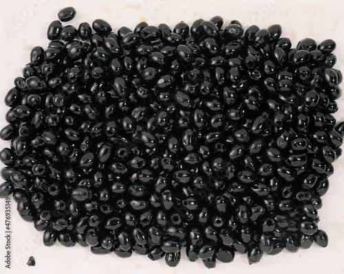Smoked market fresh black olives as background