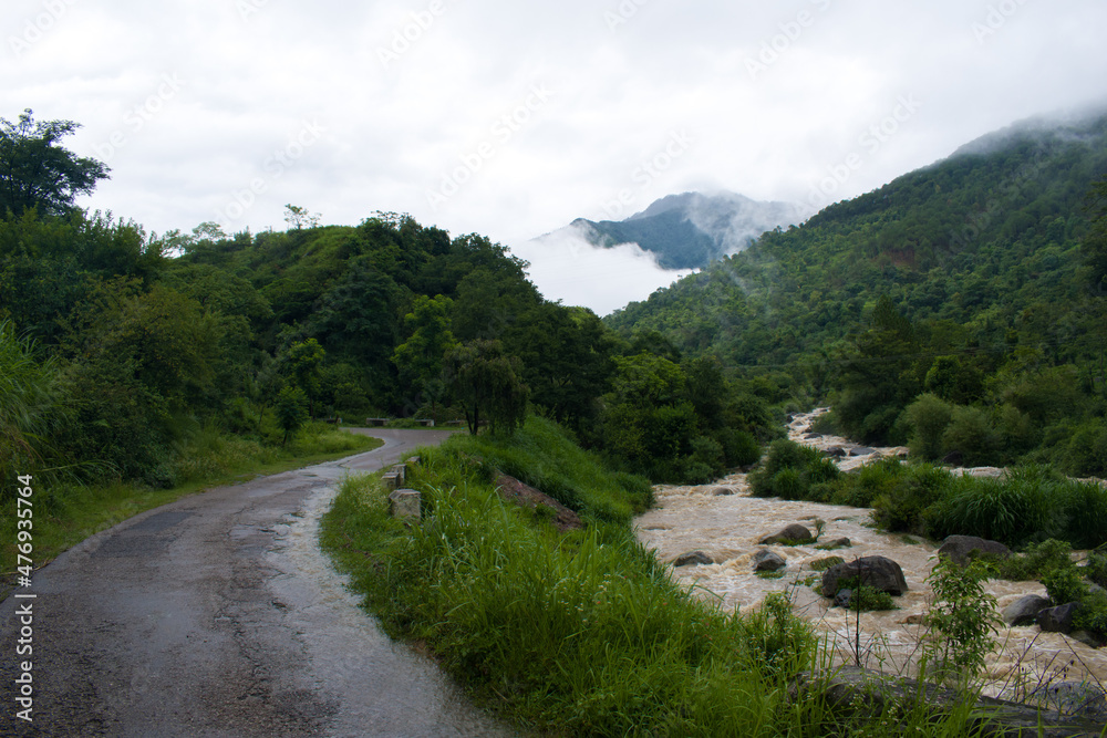 Scenery of road and river in rainy monsoon season in mountainous region