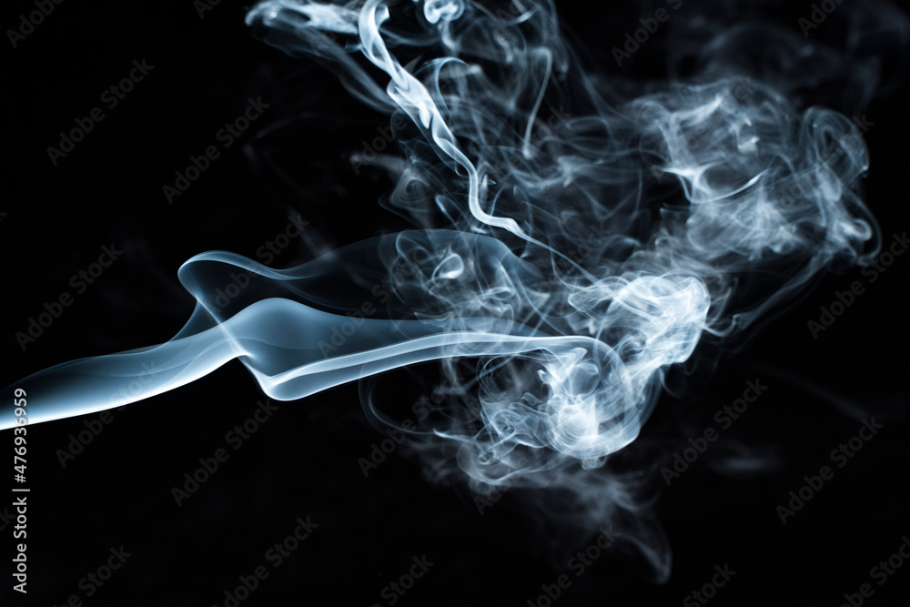 Photo of a wisp of smoke on a dark background Photo of a wisp of smoke on a dark background