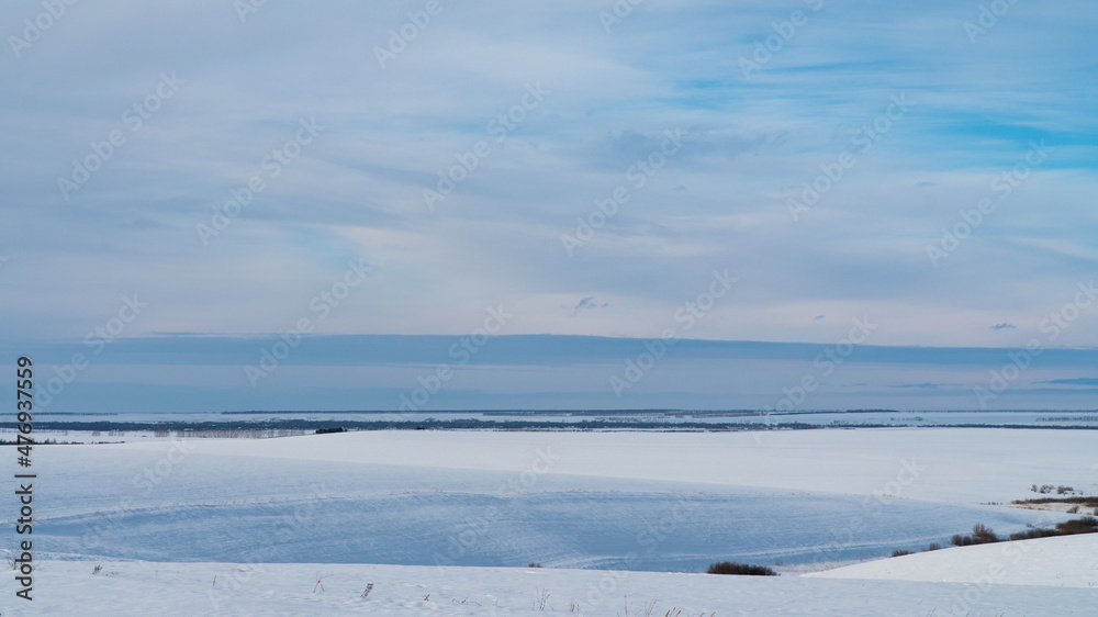 Landscape of snow covered countryside with beautiful sky