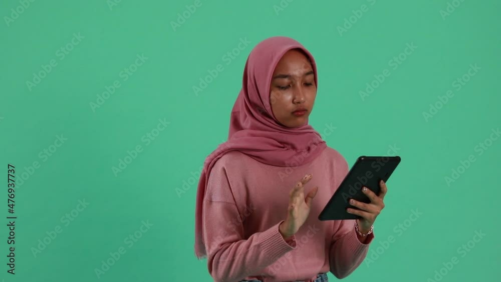 portrait of Asian Woman using smartphone on green background. portrait of Asian Woman using smartphone on green background.