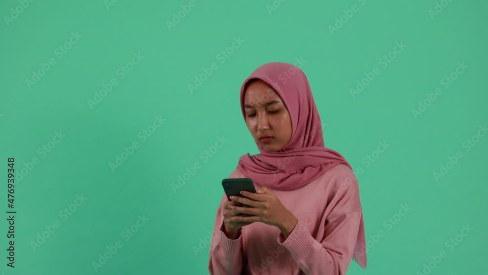 portrait of Asian Woman using smartphone on green background. portrait of Asian Woman using smartphone on green background.