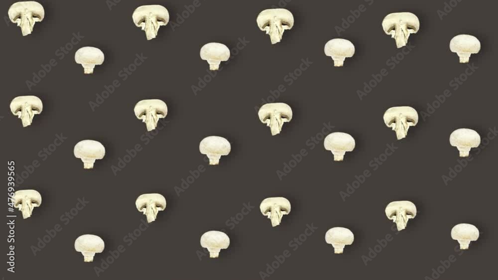 Colorful pattern of fresh mushrooms on brown background. Seamless pattern with champignon sliced. Top view. Realistic animation. 4K video motion Colorful pattern of fresh mushrooms on brown background. Seamless pattern with champignon sliced. Top view. Realistic animation. 4K video motion