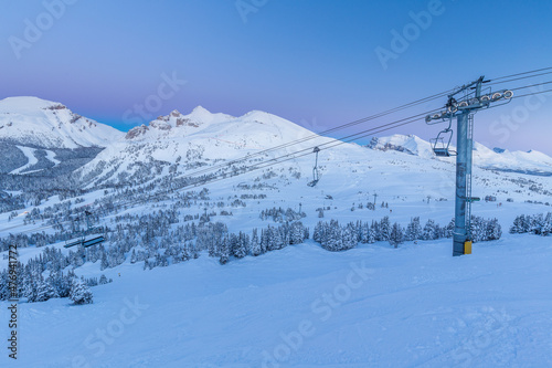 Chairlift in ski resort and mountains Sunshine Village sunset, Canada