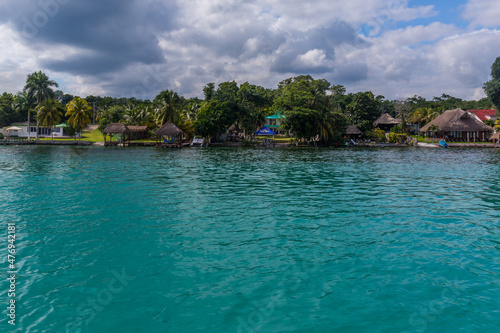 Palms and houses on the lagoon, Laguna Bacalar, Chetumal, Quintana Roo, Mexico. © Pavel
