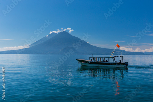 Lonely boat on the lake Atitlan in Guatemala with volcano in the background