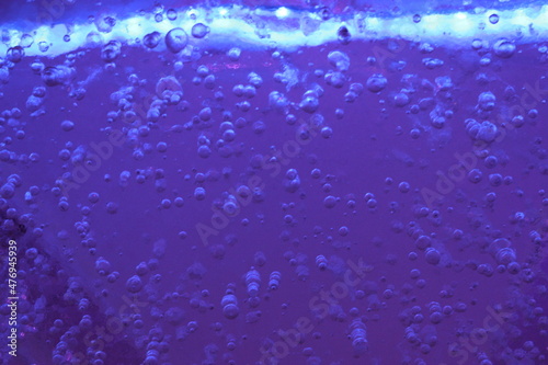 Blue ice with air bubbles close-up. Modern Abstract Background Blue Water Design Template Suitable for banner, poster, booklet, report, magazine decoration. Blue background boogie woogie light blurred photo