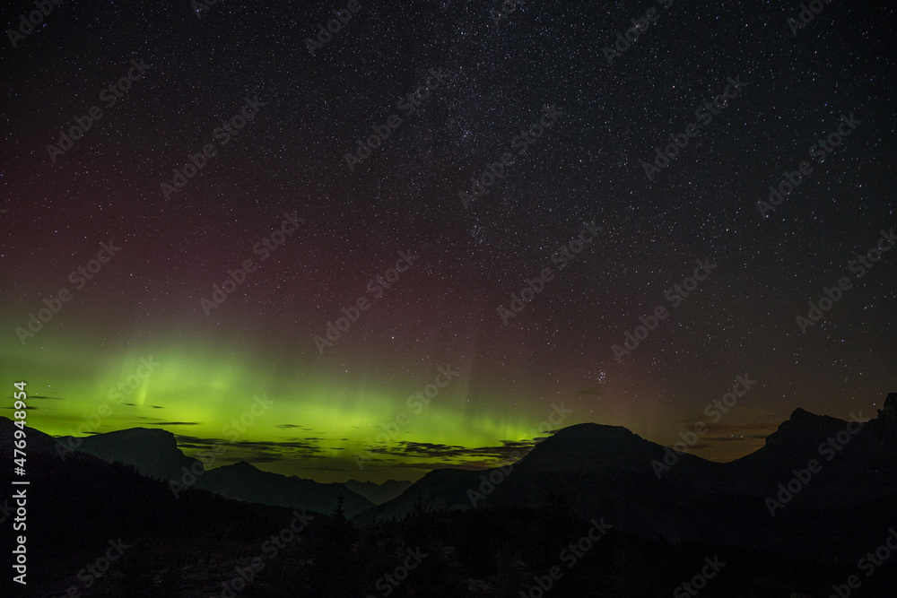 A beautiful green and red aurora dancing in Sunshine Village, Canada A beautiful green and red aurora dancing in Sunshine Village, Canada