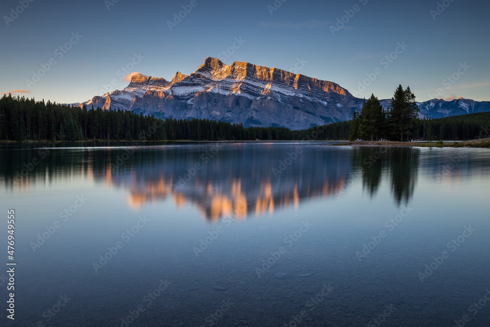Fototapeta premium Rundle Mountain reflecting in Two Jack Lake in Banff National Park at sunrise.