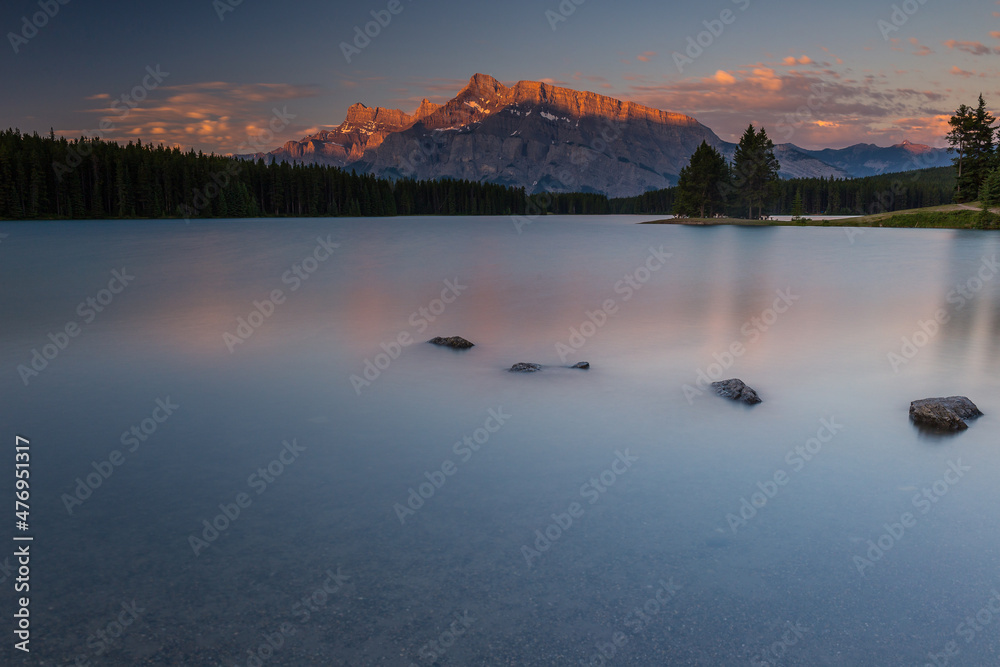 Fototapeta premium Rundle Mountain reflecting in Two Jack Lake in Banff National Park at sunrise.
