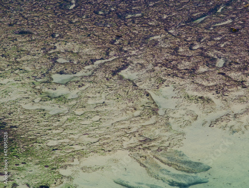 Beautiful abstract patterns on the sand at rocky beach.