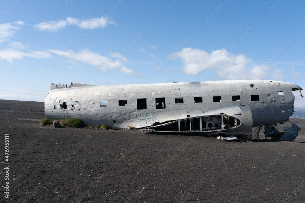 Impressive view of the Sólheimasandur Plane Wreck, the Remains of a 1973 U.S. Navy DC plane that crashed on black sand beach in Iceland Impressive view of the Sólheimasandur Plane Wreck, the Remains of a 1973 U.S. Navy DC plane that crashed on black sand beach in Iceland
