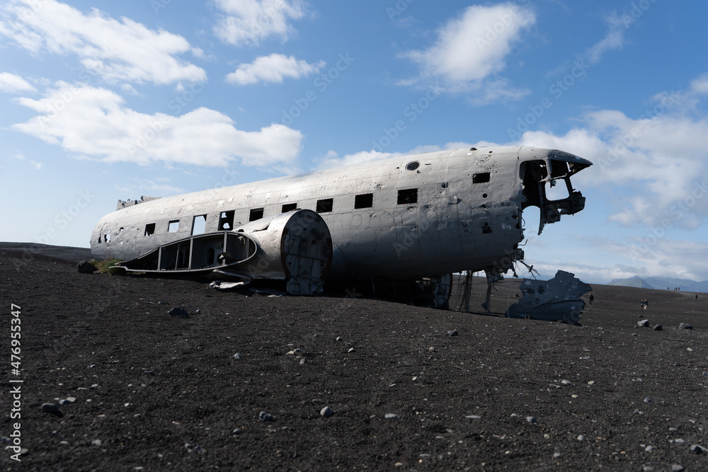 Impressive view of the Sólheimasandur Plane Wreck, the Remains of a 1973 U.S. Navy DC plane that crashed on black sand beach in Iceland Impressive view of the Sólheimasandur Plane Wreck, the Remains of a 1973 U.S. Navy DC plane that crashed on black sand beach in Iceland