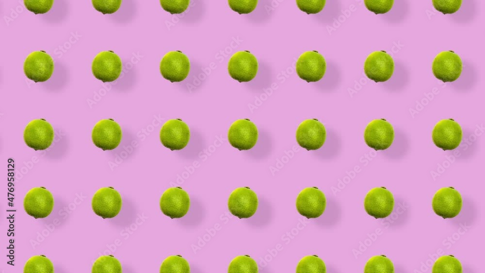 Colorful fruit pattern of fresh limes on pink background with shadows. Seamless pattern with lime. Realistic animation. 4K video motion