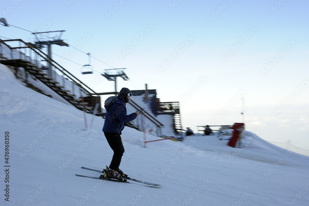 Active lifestyle and sports: rest in a ski resort. Skiing, snowboarding. Nice alpine view. Downhill