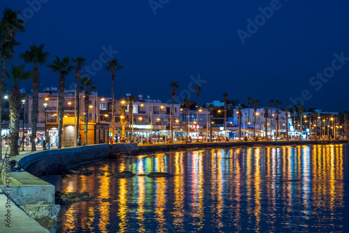 Paphos, Cyprus. 11.11.2021. Night embankment with walking tourists