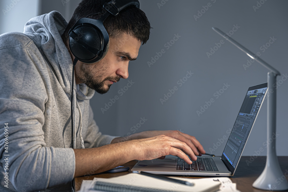 Working process at night, a musician is creating music at night. Working process at night, a musician is creating music at night.