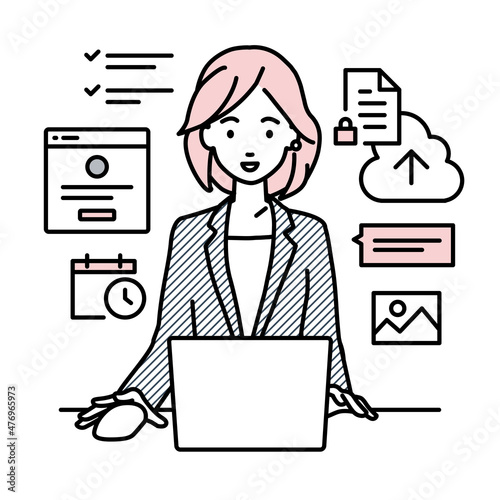 デスクで座ってPCでプロジェクトやタスクの管理の仕事をしているスーツの女性