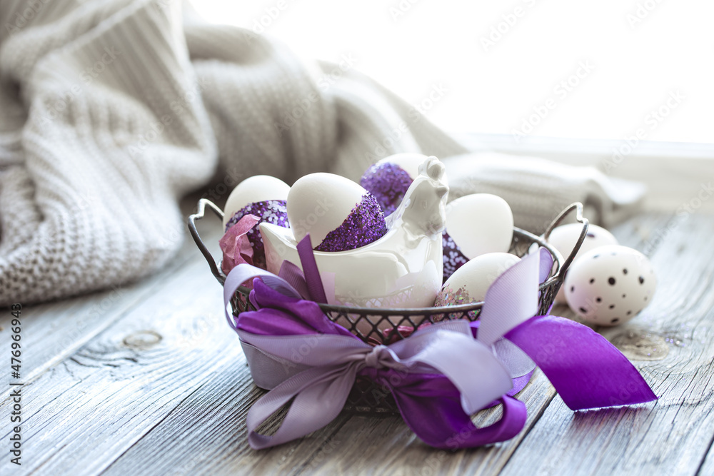 Easter composition with eggs, decorated with purple sparkles.