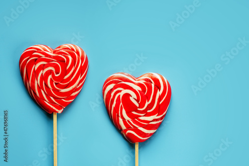 Red heart lollipops on blue background love and Valentine day background