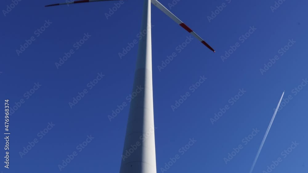 a wind turbine pan upwards in the winter sky a wind turbine pan upwards in the winter sky