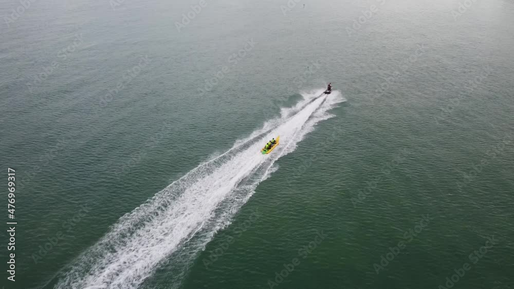4K Aerial bird eyes view of jet ski boat cruising in high speed in turquoise clear water sea. 4K Aerial bird eyes view of jet ski boat cruising in high speed in turquoise clear water sea.
