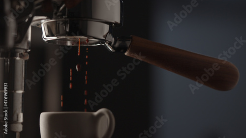pull espresso shot with bottomless portafilter on a professional coffee machine photo