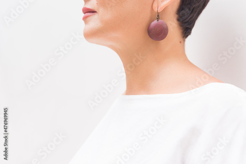 hearing, health, beauty and piercing concept - close up of woman's ear, earing