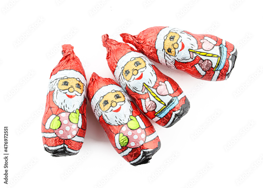 Group of chocolate santa claus figures wrapped in foil isolated on white background