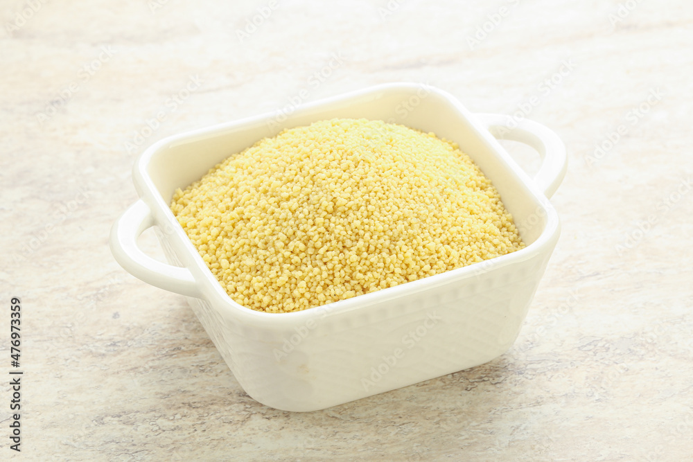 Raw couscous in the bowl Raw couscous in the bowl