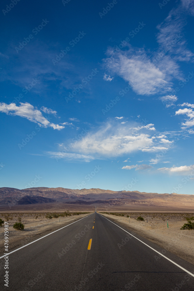 Long desert highway leading into Death Valley National Park