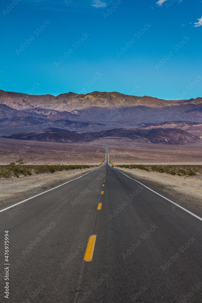 Long desert highway leading into Death Valley National Park