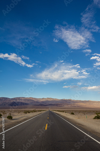 Long desert highway leading into Death Valley National Park