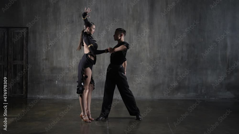 Dance ballroom couple in black dress in sensual pose on studio background. Professional dancers dancing latino. Hobby dance concept. Human emotions - love and passion Dance ballroom couple in black dress in sensual pose on studio background. Professional dancers dancing latino. Hobby dance concept. Human emotions - love and passion
