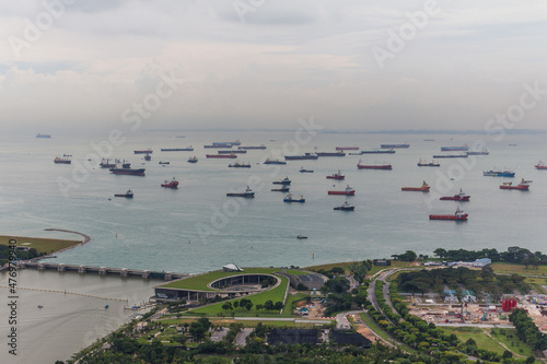 Bird eye of Landscape from bird view of Cargo ships entering one of the busiest ports in the world, over the Garden by the bay in Marina bay sand