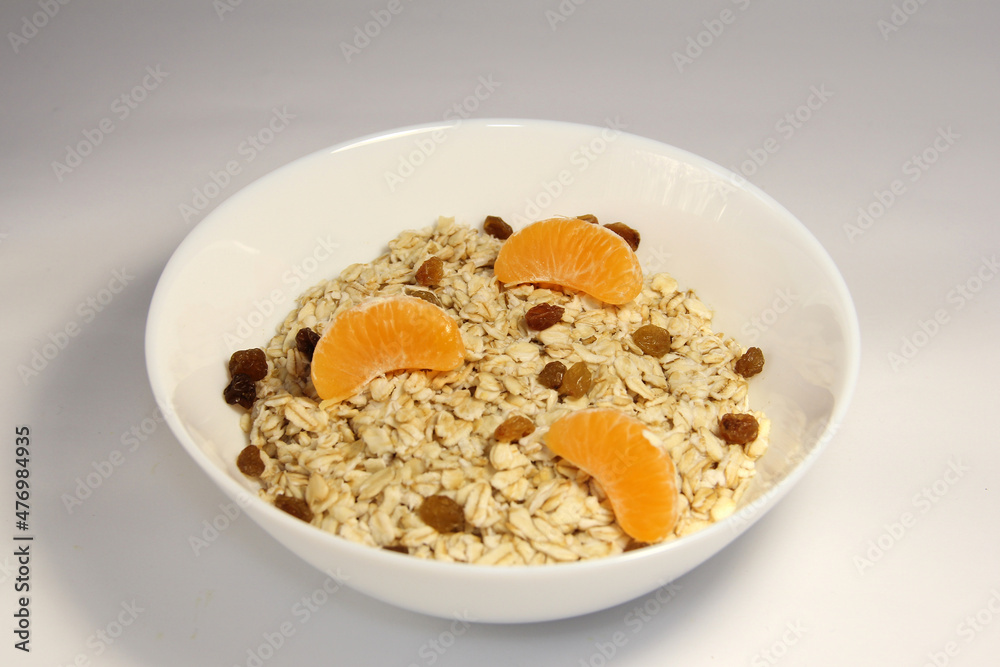 Oatmeal with slices of mandarin and raisins.