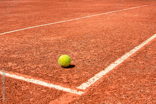 A tennis ball on a dirt court. bright sunny day. vivid colors © Denis Shitikoff