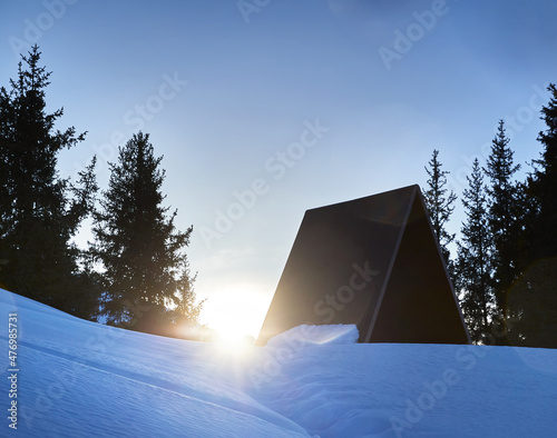 Landscape of snowy winter mountains and camp house