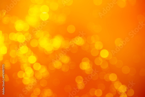Yellow soft bokeh on orange background. Yellow bokeh background photo. Background for new year, fun, season, celebration, wedding concept photos.