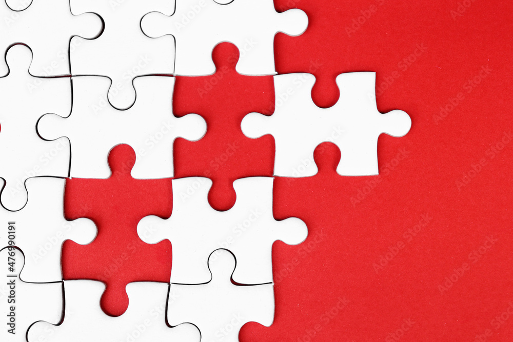 White puzzle pieces on red background, copy space for text. White puzzle pieces on red background, copy space for text.